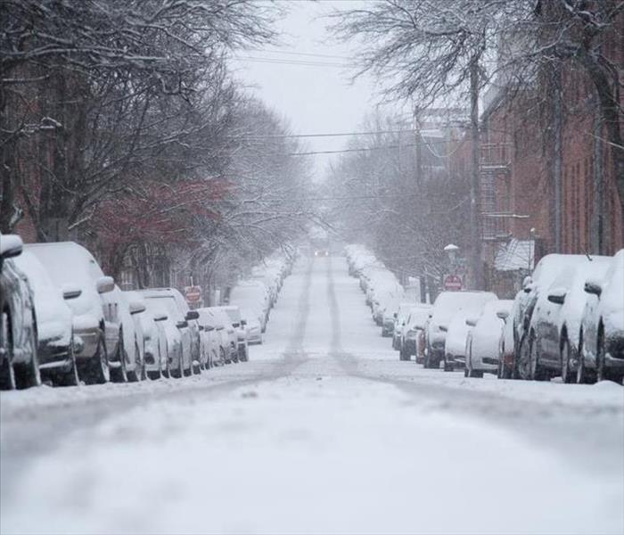 snow on street with parked cars