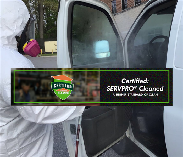 Man wearing PPE fogging a van with EPA-hospital grade disinfectant